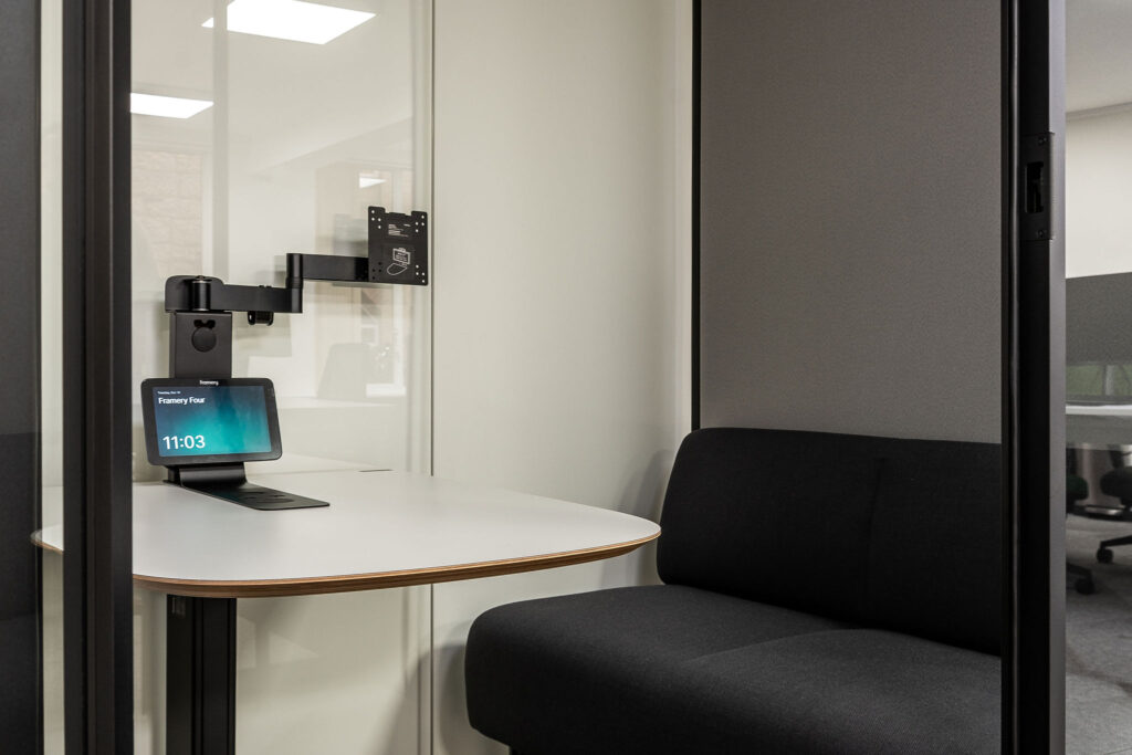 inside acoustic POD with black sofa