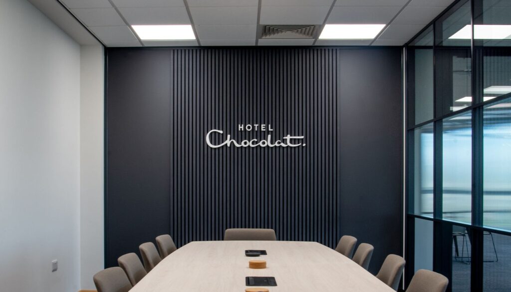Hotel chocolat sign on charcoal slatted background